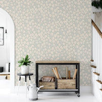 Dewy Birch Branches wallpaper in an entryway with a black console cart and a plant by the staircase