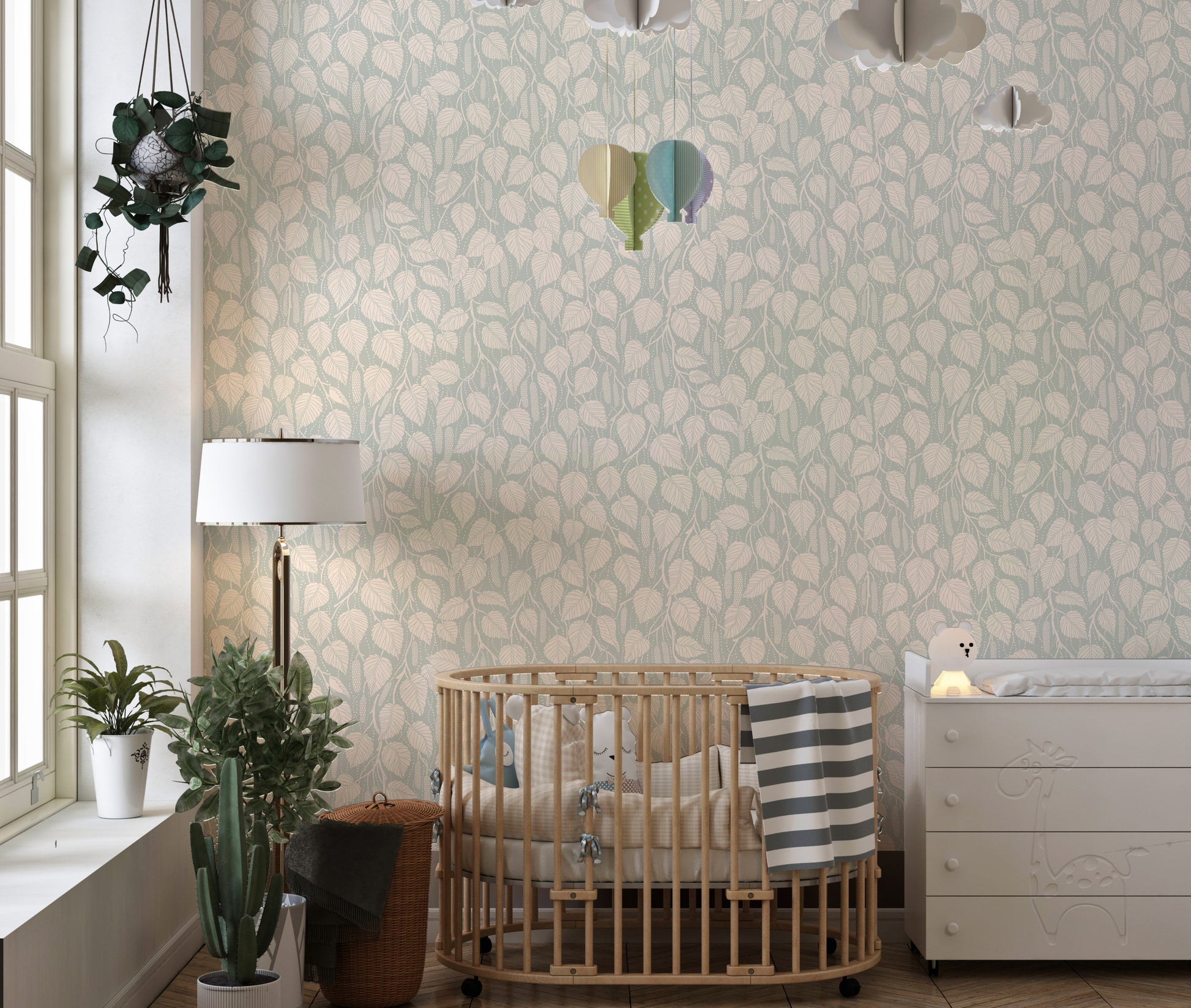 Dewy Birch Branches wallpaper in a nursery with a round wood crib, floor lamp and cloud mobile