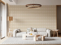 Diamond Bloom wallpaper with a cream diamond floral motif behind a grey low sofa and rattan floor lamp in a living room