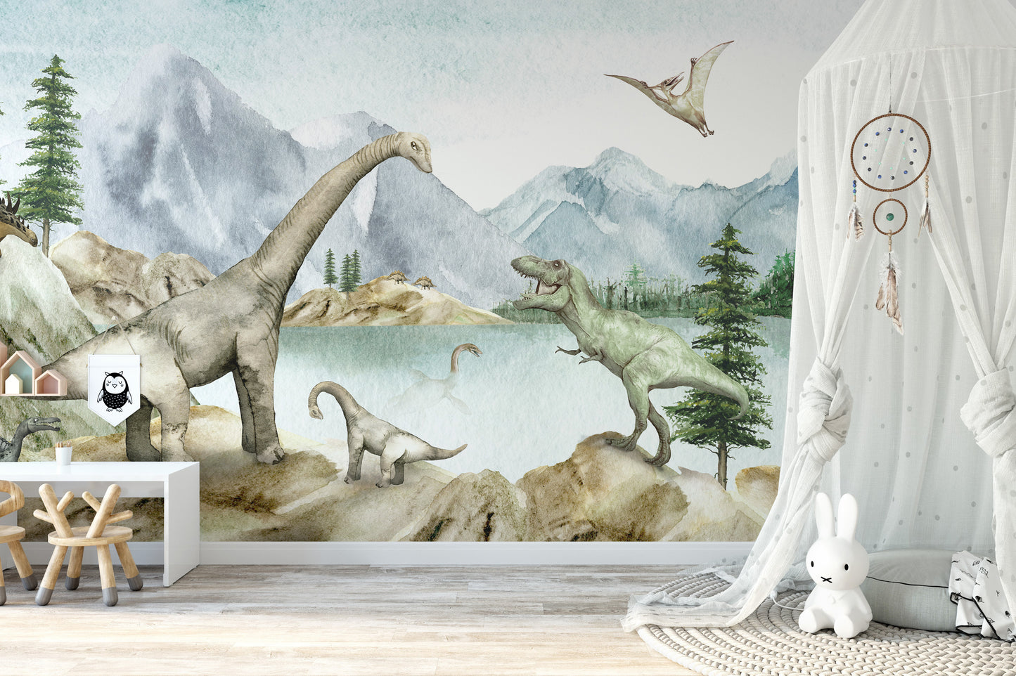 Dino dreams wallpaper mural of dinosaurs by a misty lake behind a white play desk and canopy in a kids room