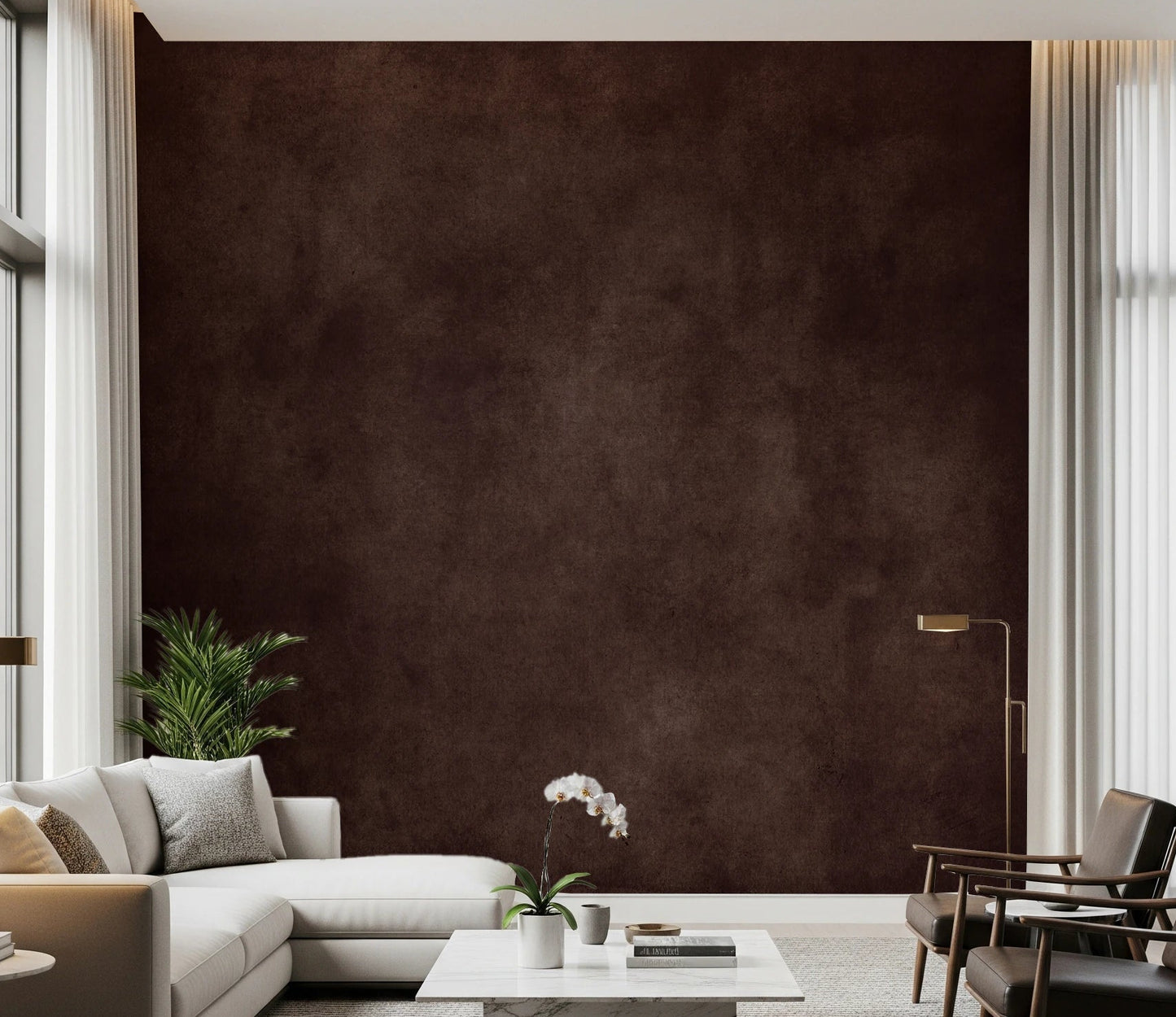 Dirty Paper Cognac wall mural in deep brown behind a cream sectional, leather chairs and an orchid in a tall living room