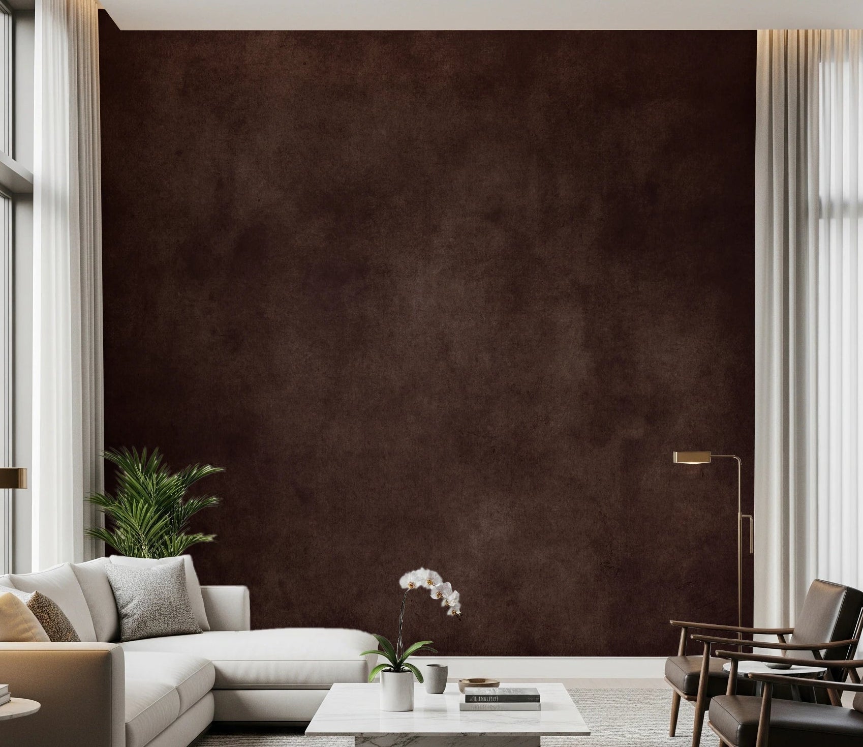 Dirty Paper Cognac wall mural in deep brown behind a cream sectional, leather chairs and an orchid in a tall living room