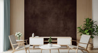 Dirty Paper Cognac wall mural in deep brown behind a white TV unit with cactus, framed by wood slat walls