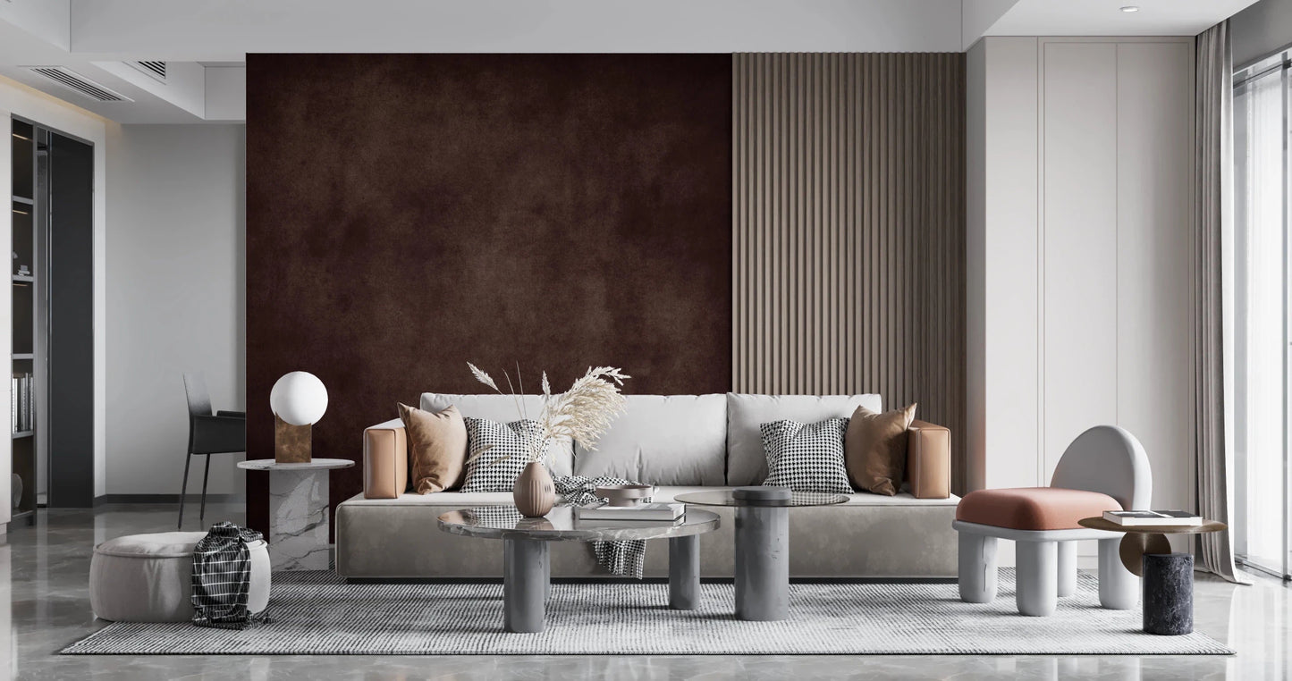 Dirty Paper Cognac wall mural in cognac brown framed by wood slats behind a grey sofa and pampas grass