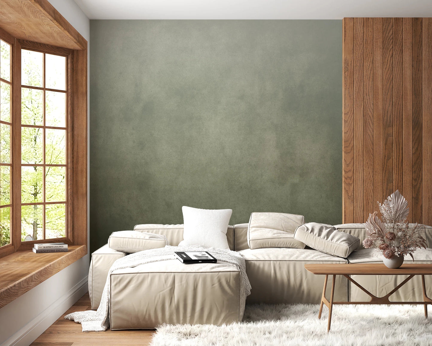 Ombre Sage wall mural beside wood paneling behind a cream sofa in a cozy living room with bay window