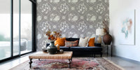 Floral tile wallpaper in home office, muted colors with simple desk and shelving
