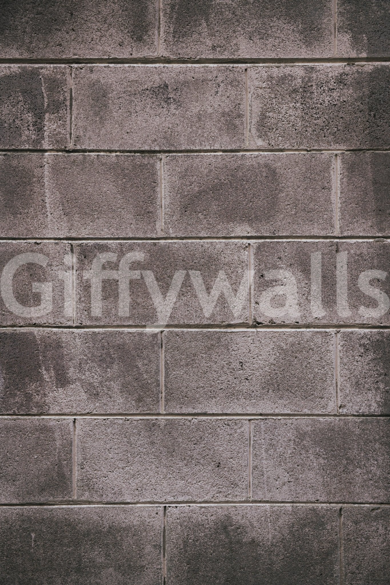 Distressed Walls wallpaper mural close-up showing the weathered grey concrete-block pattern with worn, stained surfaces