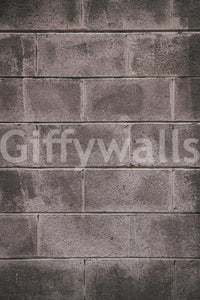 Distressed Walls wallpaper mural close-up showing the weathered grey concrete-block pattern with worn, stained surfaces