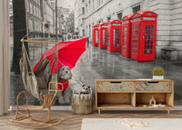 Dog sitting under a bright red umbrella.

