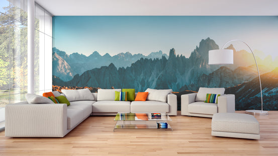 Dolomites Alps Rocky Mountain Range wallpaper mural behind a white sectional sofa in a bright living room