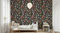 Dream Dark Birdwatcher's wallpaper of birds on a dark ground behind a white bed and rattan peacock chair