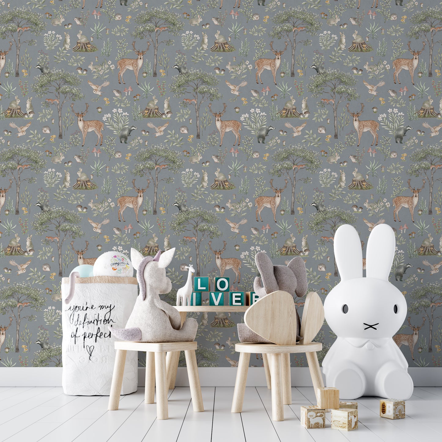 Dusty Blue Wildlife wallpaper in a play corner with a Miffy lamp, plush chairs and LOVE blocks