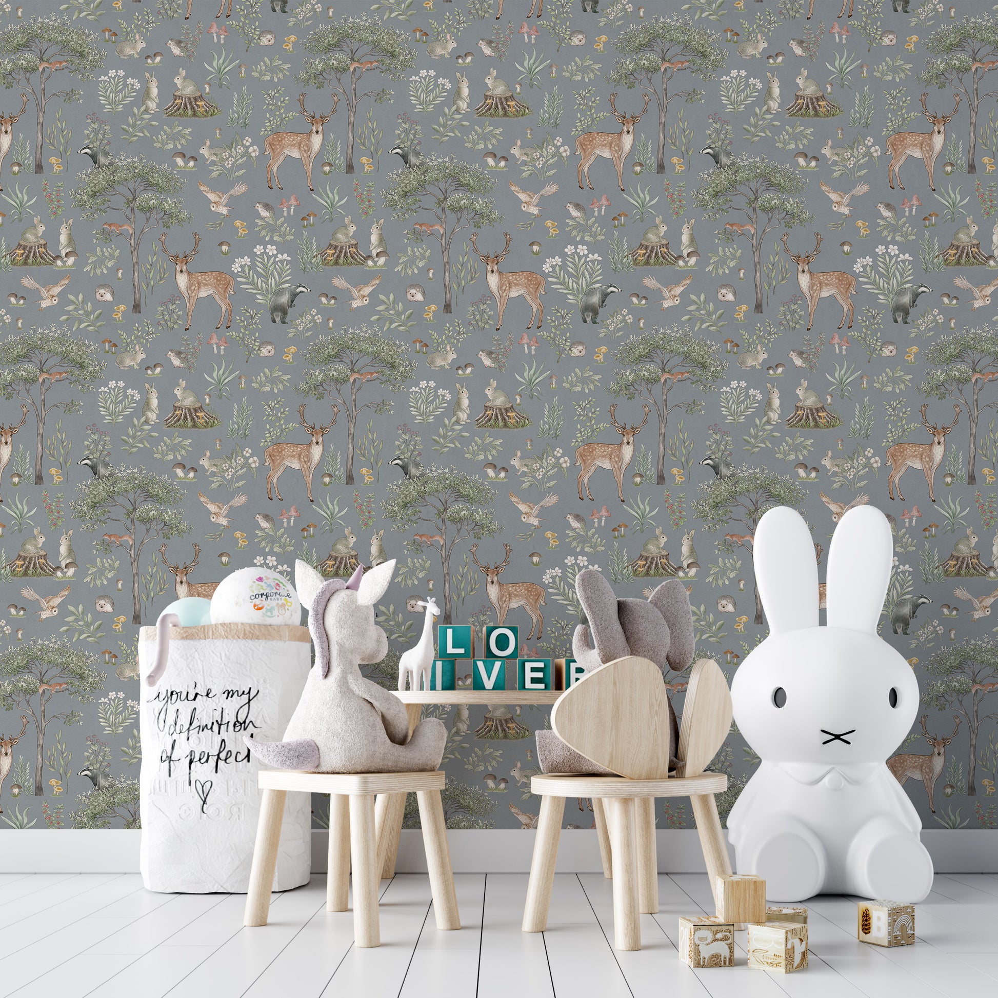 Dusty Blue Wildlife wallpaper in a play corner with a Miffy lamp, plush chairs and LOVE blocks