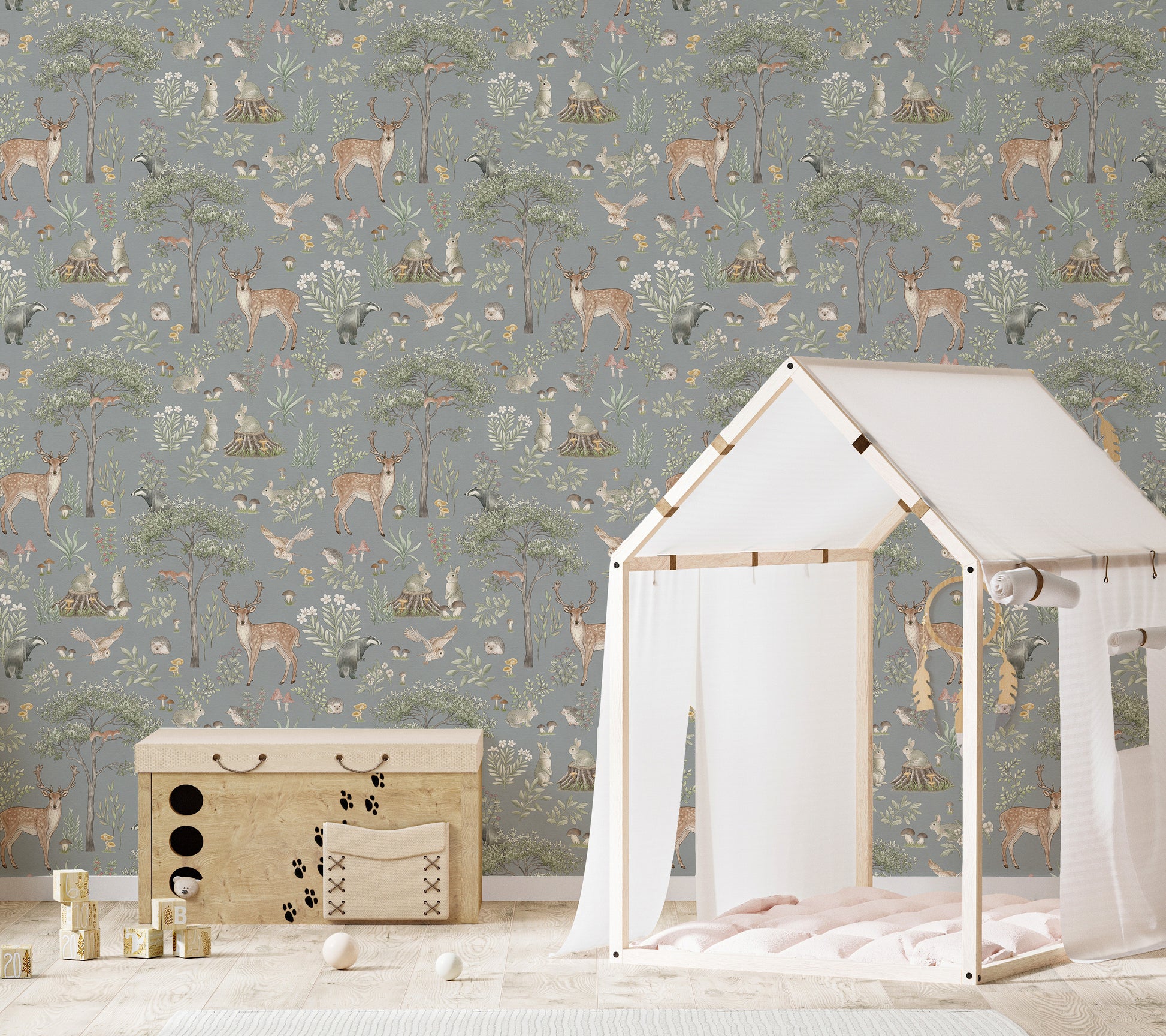 Dusty Blue Wildlife wallpaper in a kids room with a white house-frame bed and wooden toy chest