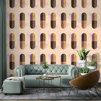 Earthy Geometric wallpaper in warm hues behind a mint-green velvet chesterfield sofa and leather chair