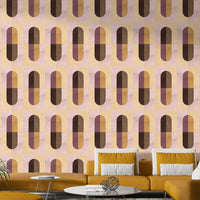 Earthy Geometric wallpaper in warm retro tones behind a mustard sofa with white and yellow cushions