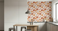 A warm earthy hearts wallpaper featuring rows of simple heart shapes in terracotta, beige, and soft peach tones.