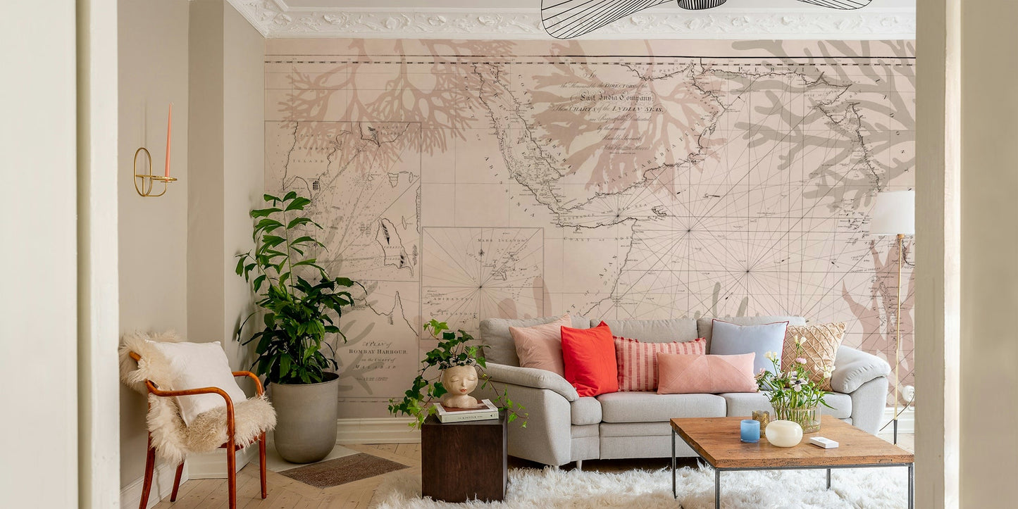 Coastal adventure mural with compass and foliage
