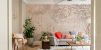 Coastal adventure mural with compass and foliage
