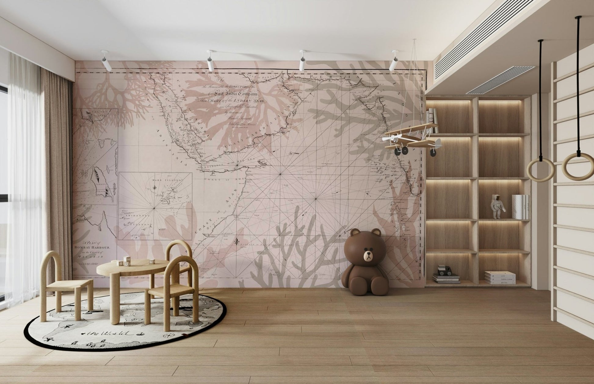 East India Trading Chart Coastal Adventure wallpaper mural in blush vintage map tones in a kids playroom with a teddy bear