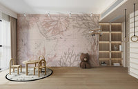 East India Trading Chart Coastal Adventure wallpaper mural in blush vintage map tones in a kids playroom with a teddy bear