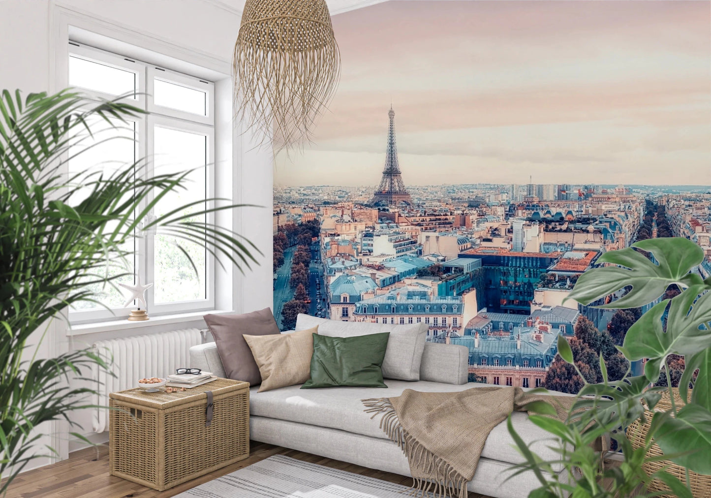 Eiffel Tower View wallpaper mural showing the Paris rooftops and tower behind a white daybed and leafy plants in a living room