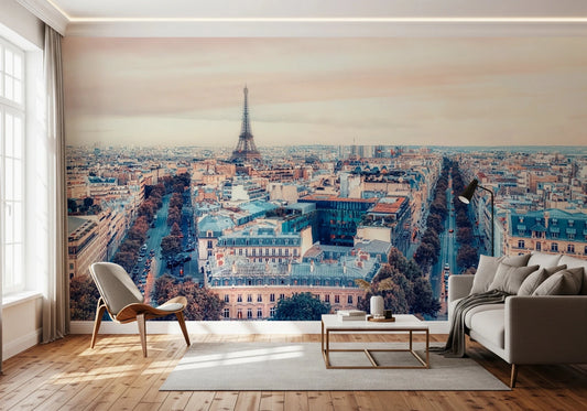 Eiffel Tower View wallpaper mural showing the sunlit Paris skyline behind a grey sofa and wishbone chair in a living room