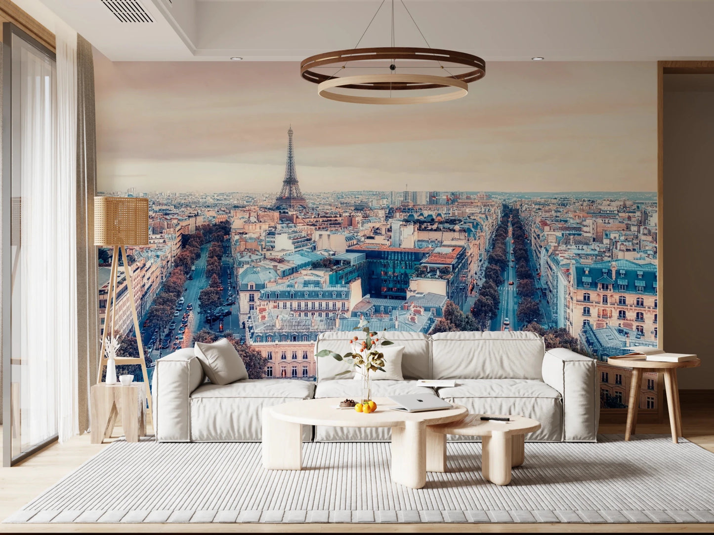 Eiffel Tower View wallpaper mural of the Paris rooftops and tower behind a white sofa under a round pendant in a living room