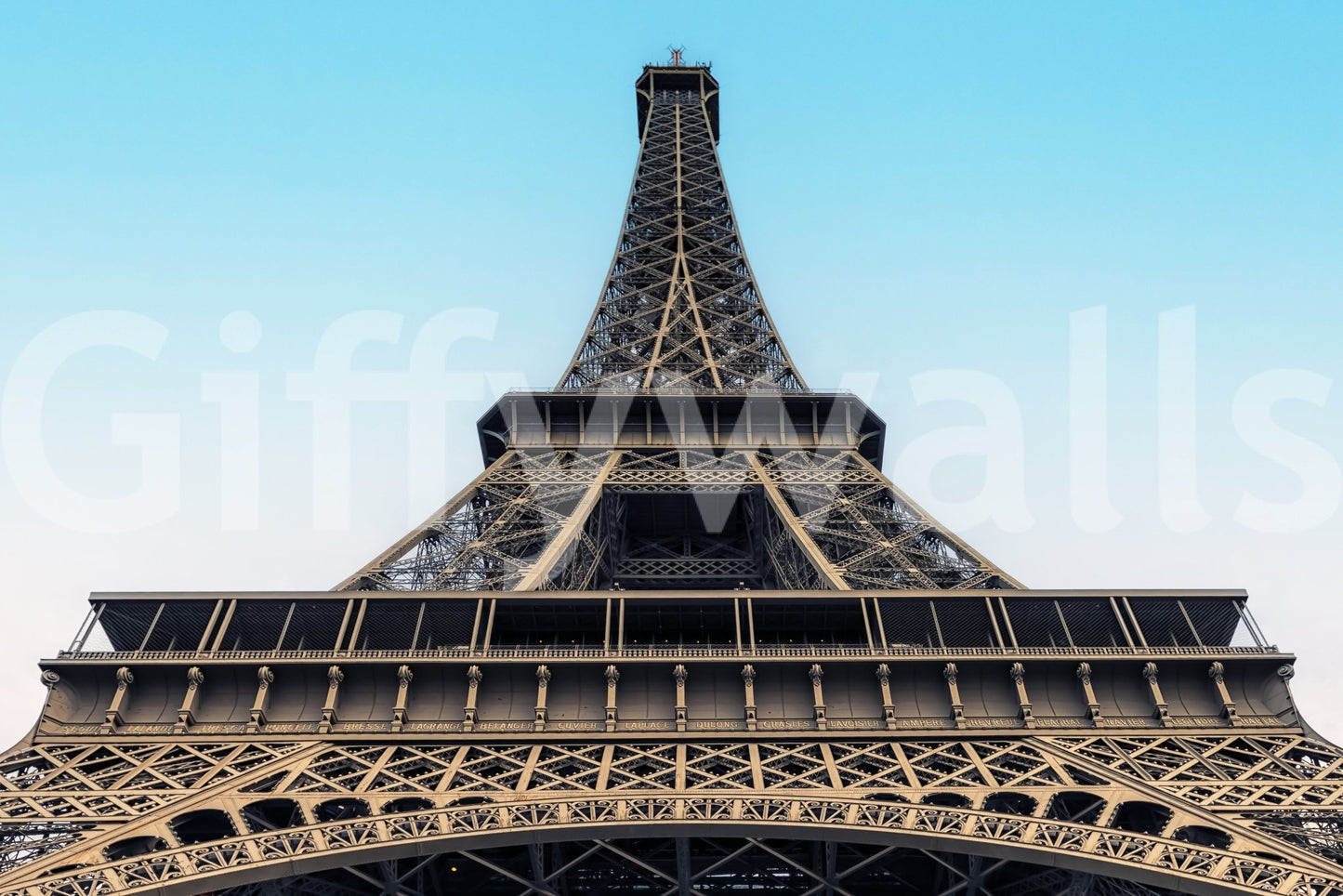 Eiffel's Azure Ascent wallpaper mural shown close-up, the Eiffel Tower viewed from below against an azure sky