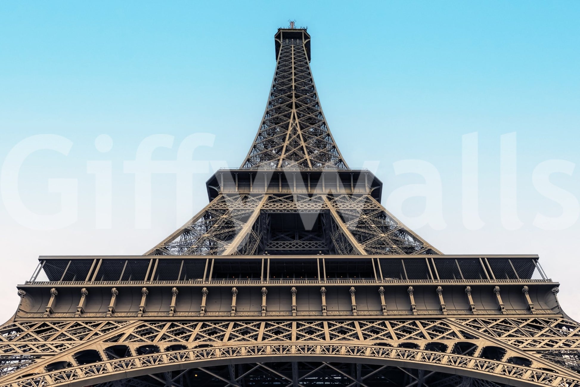 Eiffel's Azure Ascent wallpaper mural shown close-up, the Eiffel Tower viewed from below against an azure sky