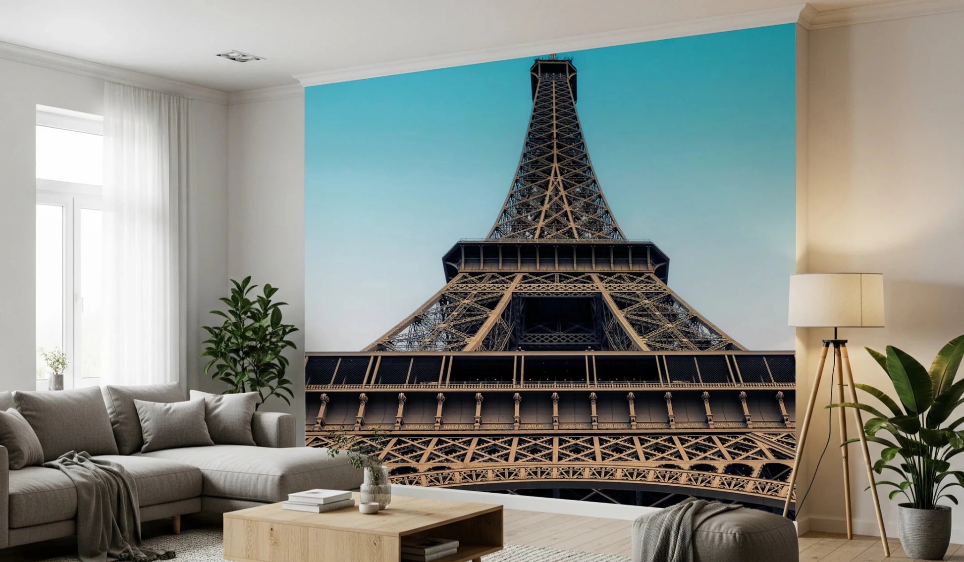 Eiffel's Azure Ascent wallpaper mural of the Eiffel Tower behind a grey sectional and tripod lamp in a living room