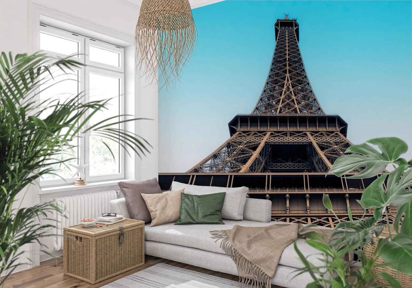 Eiffel's Azure Ascent wallpaper mural with the Eiffel Tower behind a white sofa among leafy plants in a living room