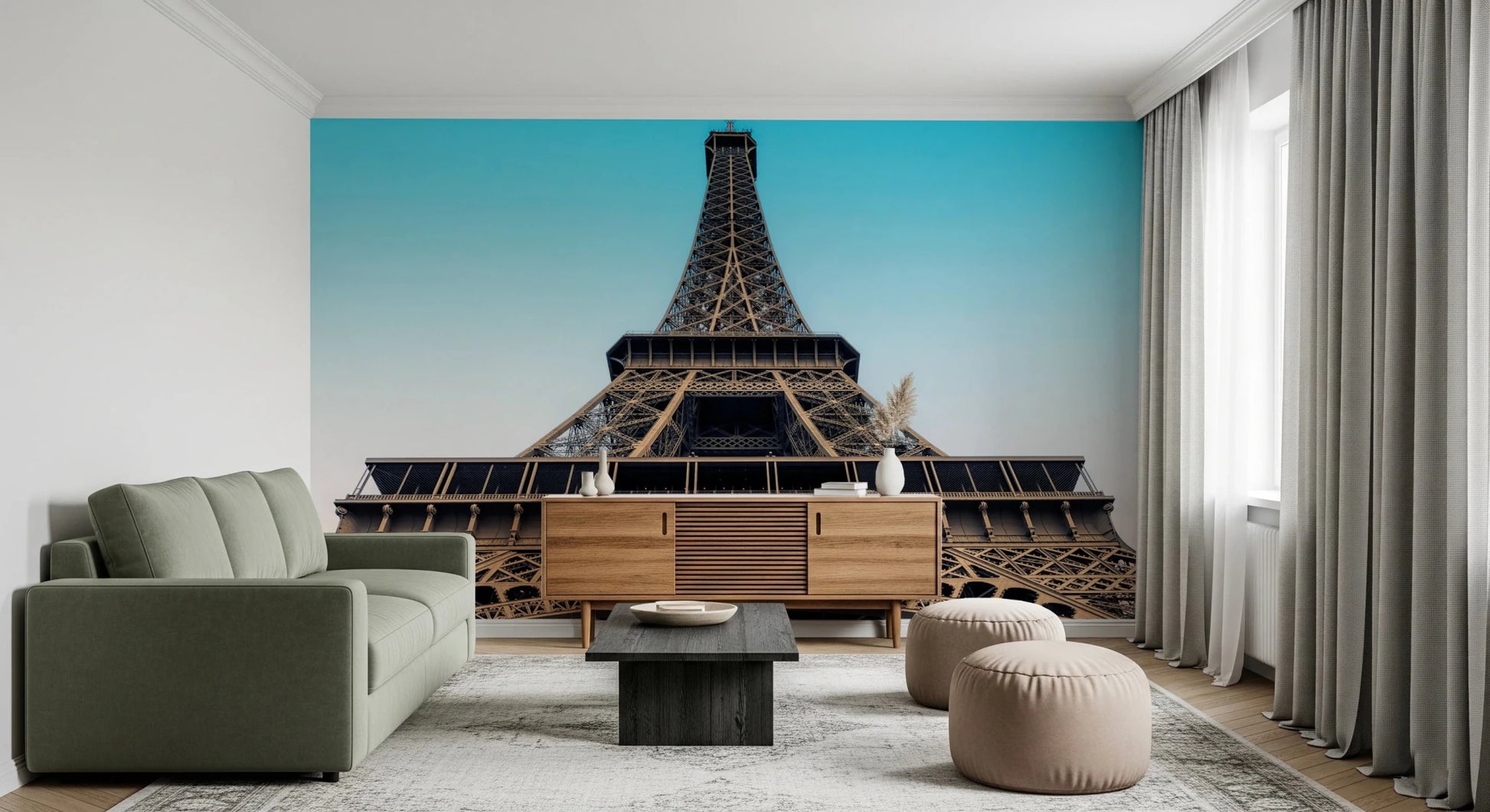 Eiffel's Azure Ascent wallpaper mural with the Eiffel Tower behind a sage green sofa and wood sideboard in a living room