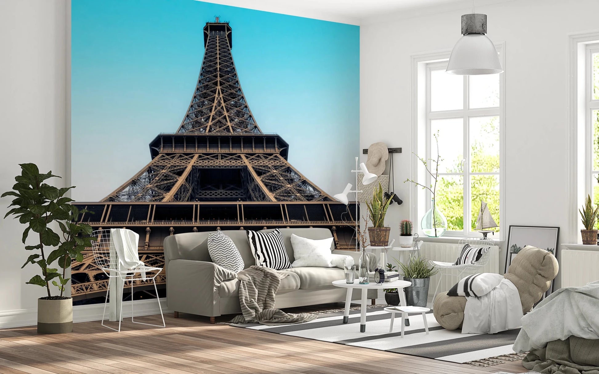 Eiffel's Azure Ascent wallpaper mural with the Eiffel Tower behind a cream sofa in a Scandinavian style living room