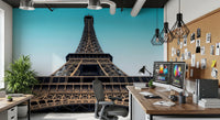 Eiffel's Azure Ascent wallpaper mural of the Eiffel Tower behind a dual-monitor desk in a home office