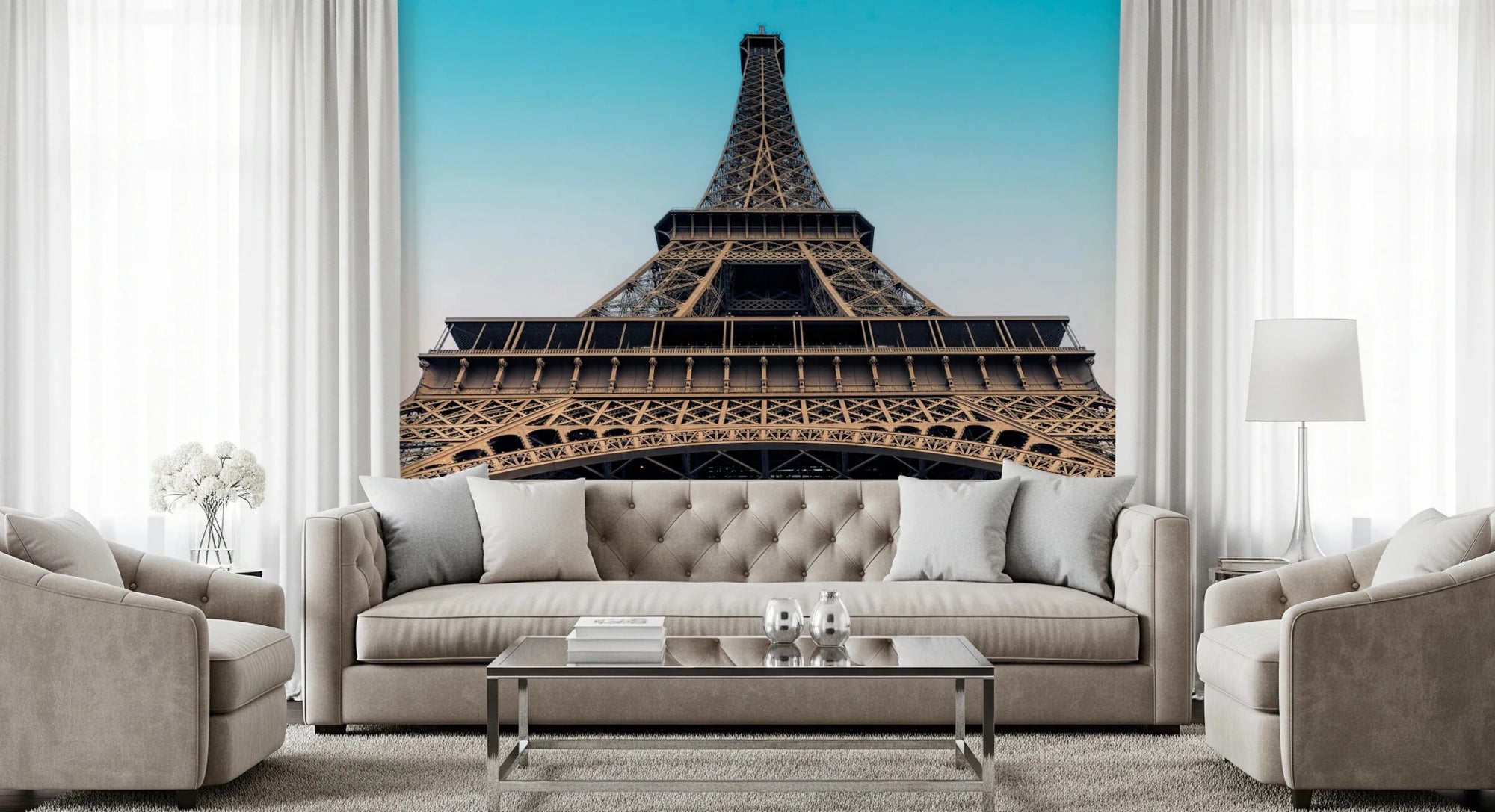 Eiffel's Azure Ascent wallpaper mural of the Eiffel Tower against a turquoise sky above a beige tufted sofa