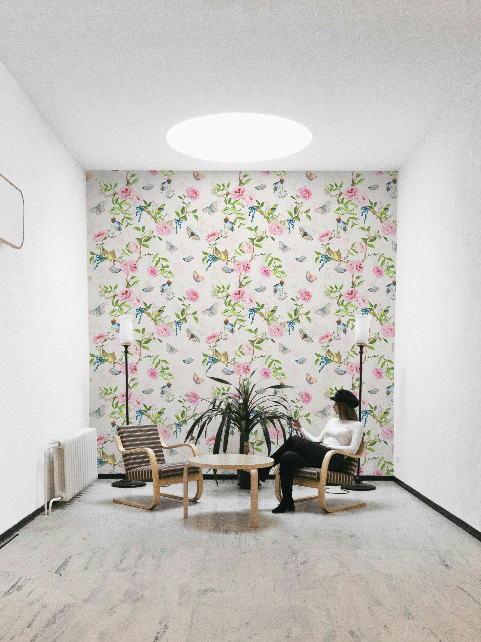 Enchanted garden mural in soft pinks, greens, and neutrals.

