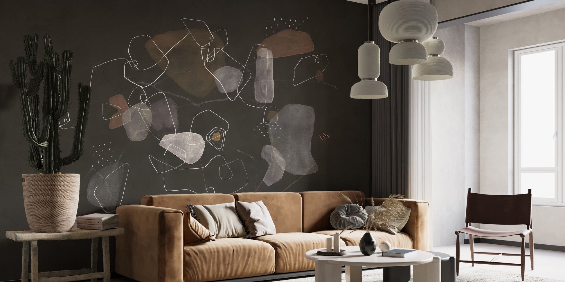 Enigmatic Cosmic wallpaper mural on a dark wall behind a tan velvet sofa and tall cactus in a living room