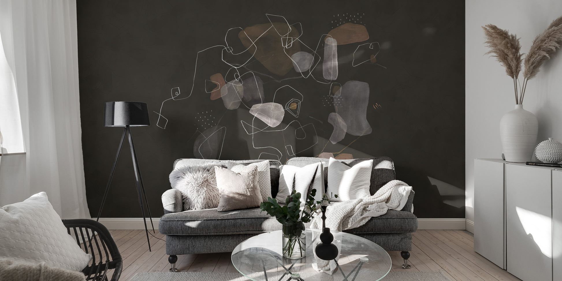 Enigmatic Cosmic wallpaper mural of muted organic shapes behind a gray sofa with a black tripod lamp in a living room