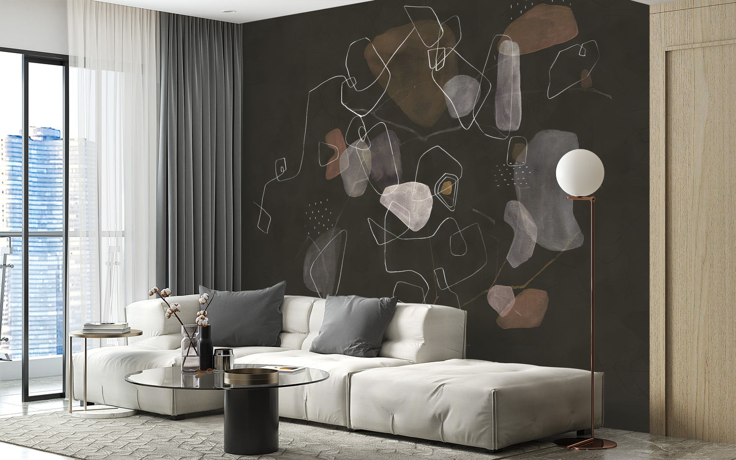 Enigmatic Cosmic wallpaper mural in dark charcoal with abstract shapes behind a white sectional and globe lamp in a living room