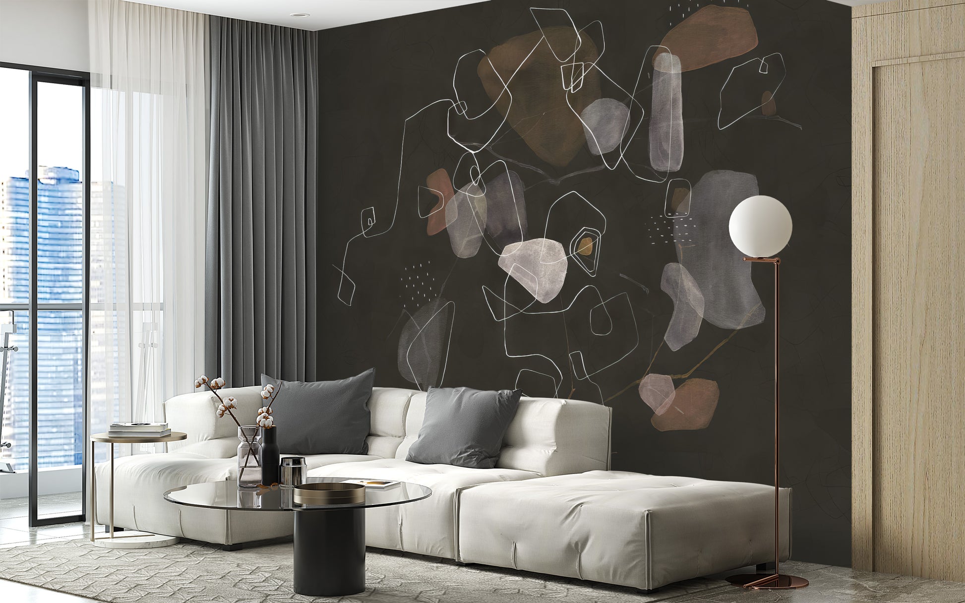 Enigmatic Cosmic wallpaper mural in dark charcoal with abstract shapes behind a white sectional and globe lamp in a living room
