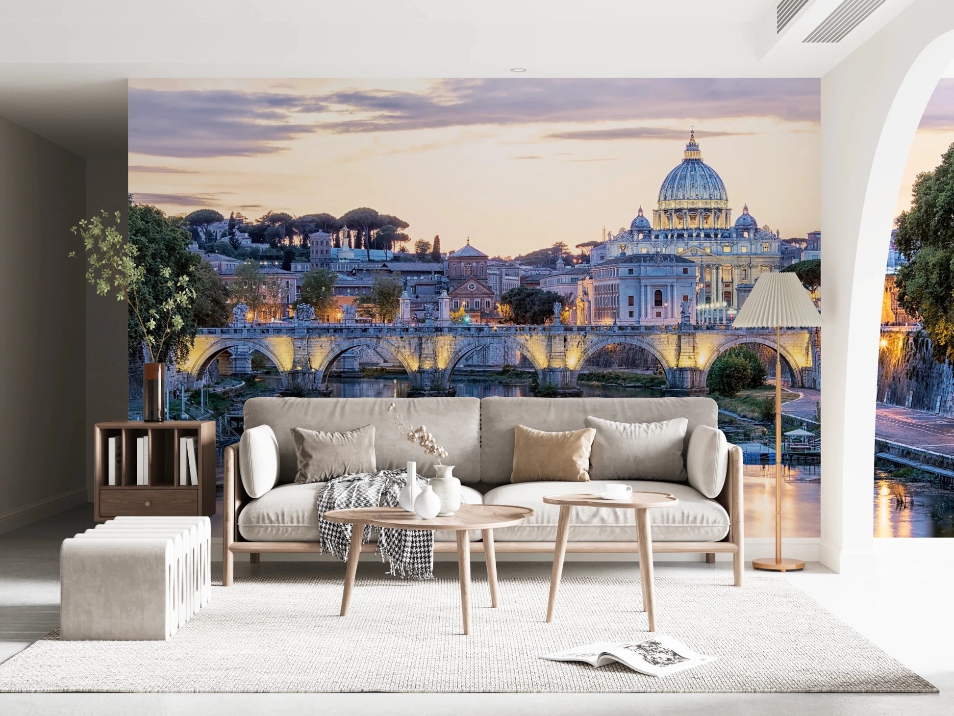 Eternal City Lights wallpaper mural of the Rome skyline at dusk above a beige sofa and two round wood tables