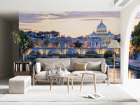 Eternal City Lights wallpaper mural of the Rome skyline at dusk above a beige sofa and two round wood tables