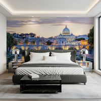 Eternal City Lights wallpaper mural of Rome at dusk behind a dark grey leather bed and black marble bench