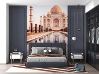 Eternal Taj wallpaper mural of the golden Taj Mahal above a grey bed framed by navy wall panels in a bedroom