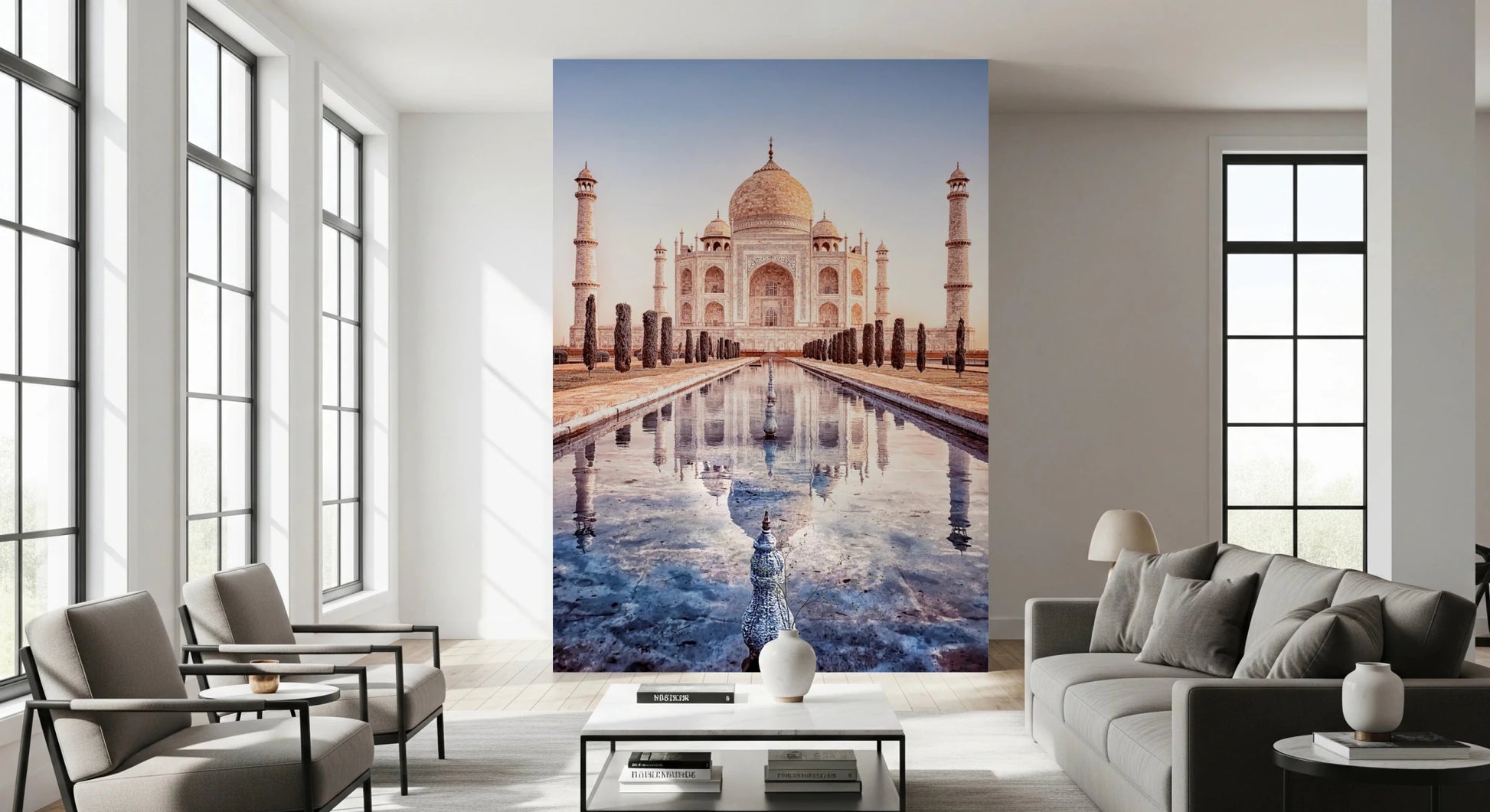 Eternal Taj wallpaper mural of the Taj Mahal and pool behind a grey sofa and two armchairs in a living room