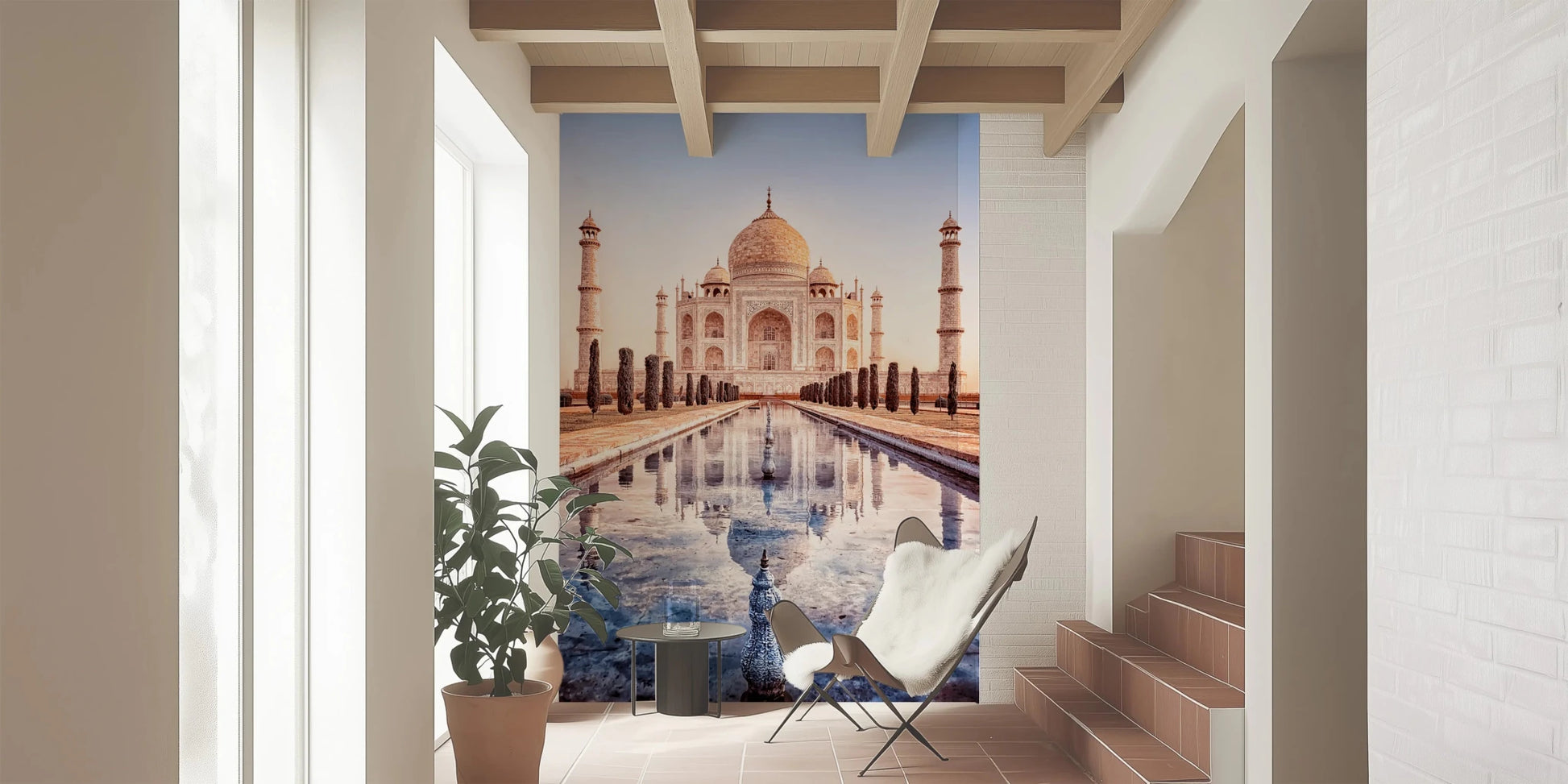 Eternal Taj wallpaper mural of the Taj Mahal in a bright entryway with a white butterfly chair beside stairs