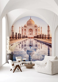 Eternal Taj wallpaper mural of the Taj Mahal under an arch behind a white togo sofa and lounge chair