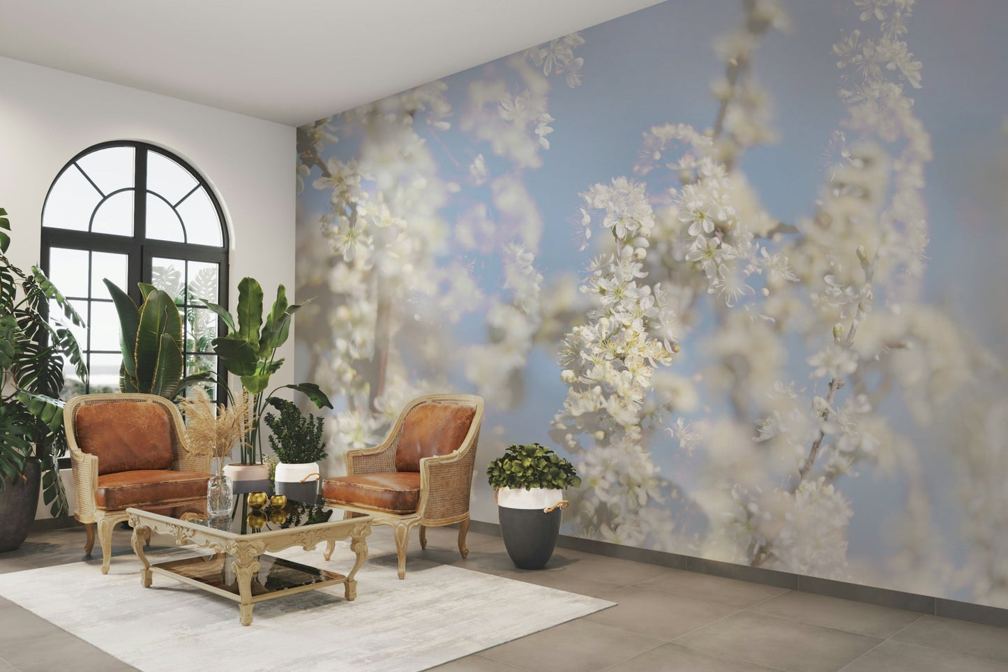 Ethereal Blossom Photography soft white floral wall mural by an arched window with two tan leather armchairs and plants