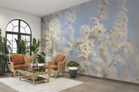 Ethereal Blossom Photography soft white floral wall mural by an arched window with two tan leather armchairs and plants